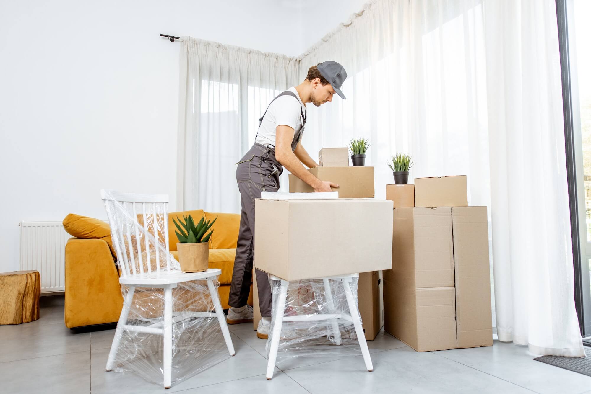 professional mover delivering furniture to a new house 1